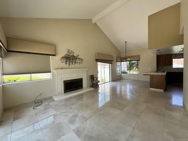 14109 Arbolitos Dr, Poway, CA 92064 - unfurnished living room featuring beam ceiling, a fireplace with raised hearth, and high vaulted ceiling