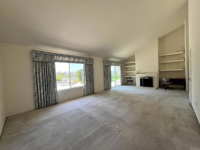 14109 Arbolitos Dr, Poway, CA 92064 - unfurnished living room featuring vaulted ceiling, built in shelves, a fireplace, and carpet