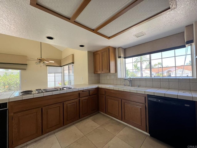 14109 Arbolitos Dr, Poway, CA 92064 - kitchen with black dishwasher, electric stovetop, a textured ceiling, healthy amount of natural light, and backsplash