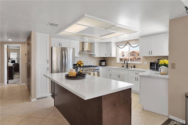 14616 Lighthouse Ln, Helendale, CA 92342 - kitchen with wall chimney exhaust hood, light tile patterned flooring, decorative backsplash, and recessed lighting