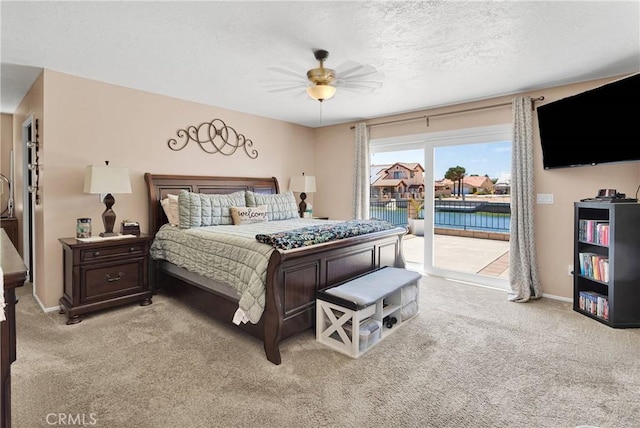 14616 Lighthouse Ln, Helendale, CA 92342 - bedroom featuring light carpet, access to exterior, a textured ceiling, and a ceiling fan