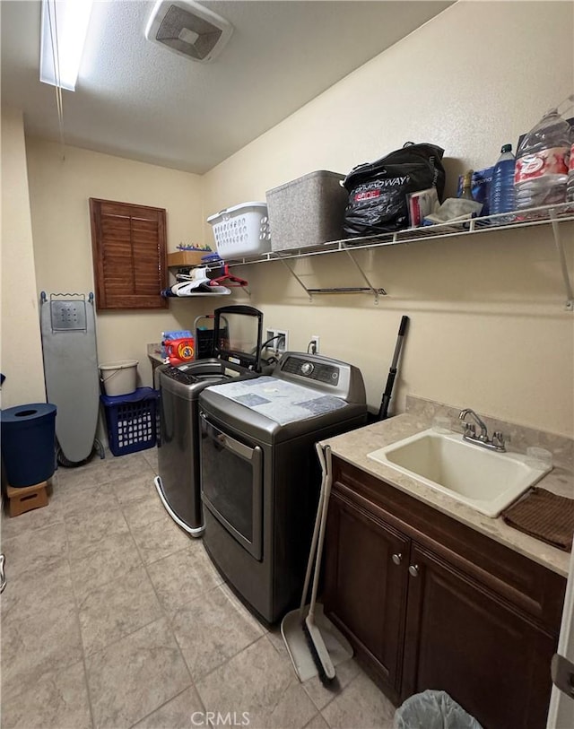 2944 E Via Terrano, Ontario, CA 91764 - laundry room with washer and dryer, cabinet space, and light tile patterned floors