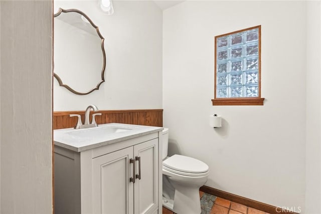 31 Pebblewood Pines Dr, Chico, CA 95926 - half bathroom featuring vanity, tile patterned floors, wainscoting, and wooden walls