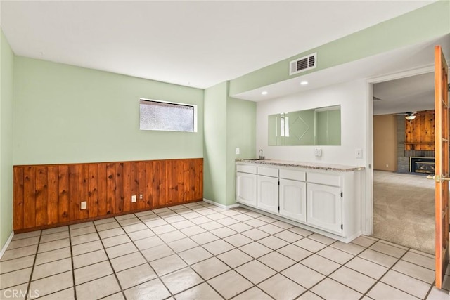 31 Pebblewood Pines Dr, Chico, CA 95926 - spare room with a glass covered fireplace, wooden walls, recessed lighting, wainscoting, and a ceiling fan