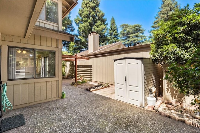 31 Pebblewood Pines Dr, Chico, CA 95926 - view of patio with a storage unit and a pergola