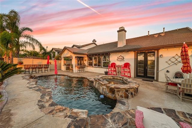 32872 Northshire Cir, Temecula, CA 92592 - pool at dusk with a patio and a pool with connected hot tub