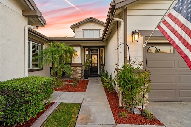 32872 Northshire Cir, Temecula, CA 92592 - exterior entry at dusk featuring stucco siding and a garage