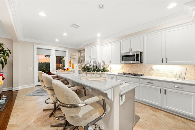 32872 Northshire Cir, Temecula, CA 92592 - kitchen with stainless steel appliances, recessed lighting, a kitchen bar, backsplash, and a center island
