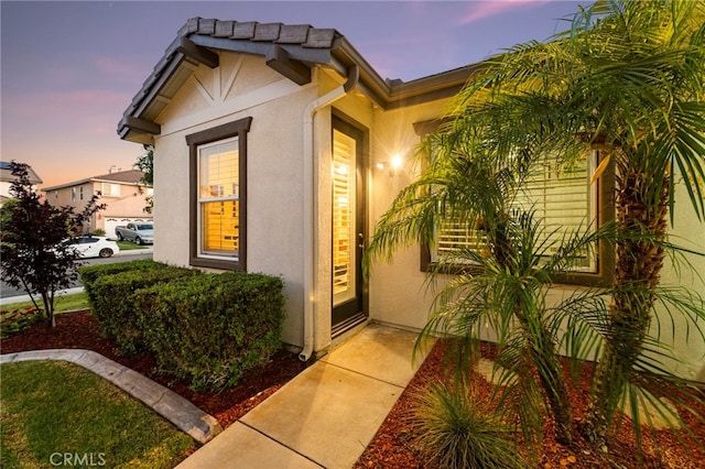 32872 Northshire Cir, Temecula, CA 92592 - exterior entry at dusk featuring stucco siding