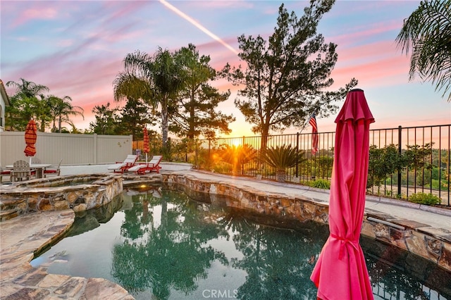 32872 Northshire Cir, Temecula, CA 92592 - pool at dusk featuring a fenced backyard and a pool with connected hot tub