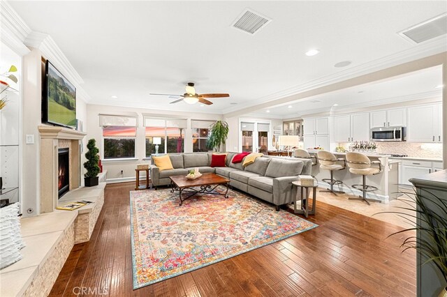 32872 Northshire Cir, Temecula, CA 92592 - living room featuring hardwood / wood-style flooring, a lit fireplace, crown molding, ceiling fan, and recessed lighting