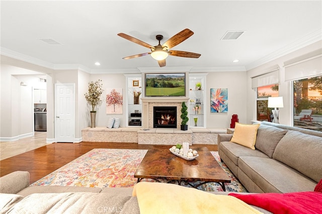 32872 Northshire Cir, Temecula, CA 92592 - living room with ceiling fan, recessed lighting, a lit fireplace, and ornamental molding