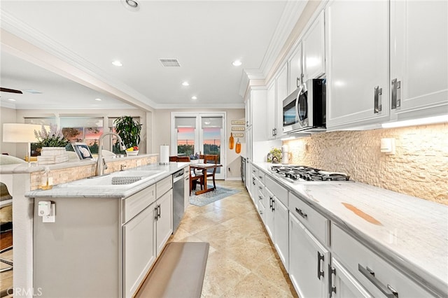 32872 Northshire Cir, Temecula, CA 92592 - kitchen featuring stainless steel appliances, ornamental molding, decorative backsplash, a kitchen island with sink, and recessed lighting