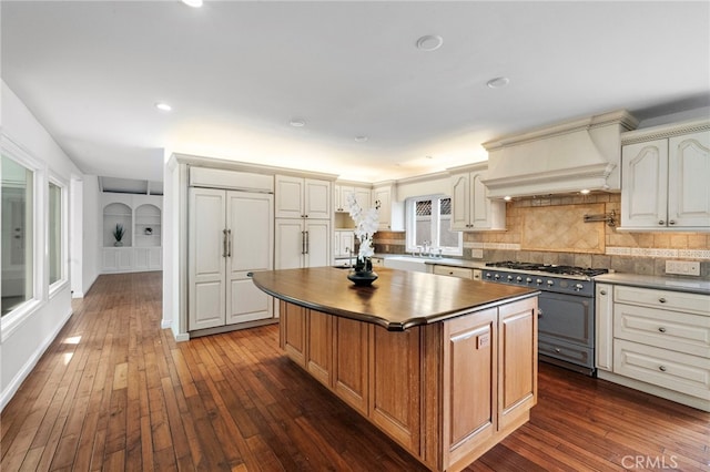 2030 Goldeneye Pl, Costa Mesa, CA 92626 - kitchen featuring high end stainless steel range oven, custom exhaust hood, dark countertops, a kitchen island, and dark wood-style floors