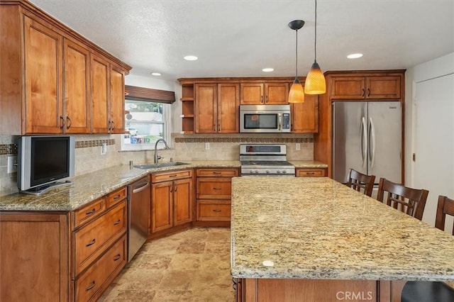 15144 Poppy Meadow St, Canyon Country, CA 91387 - kitchen with stainless steel appliances, a breakfast bar, brown cabinetry, and recessed lighting