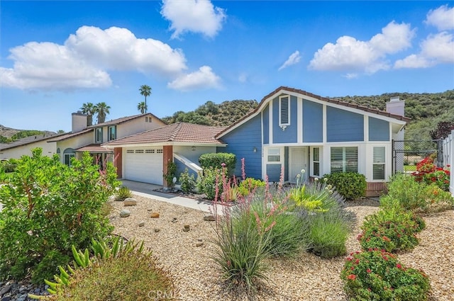 15144 Poppy Meadow St, Canyon Country, CA 91387 - view of front of home featuring an attached garage, a tile roof, and a chimney