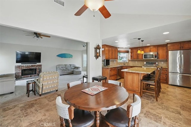 15144 Poppy Meadow St, Canyon Country, CA 91387 - dining room featuring ceiling fan, recessed lighting, high vaulted ceiling, and light stone finish floors
