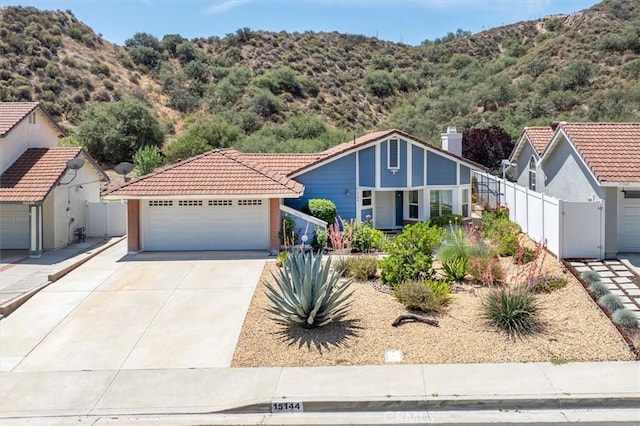 15144 Poppy Meadow St, Canyon Country, CA 91387 - view of front facade featuring a tiled roof, a mountain view, and a detached garage