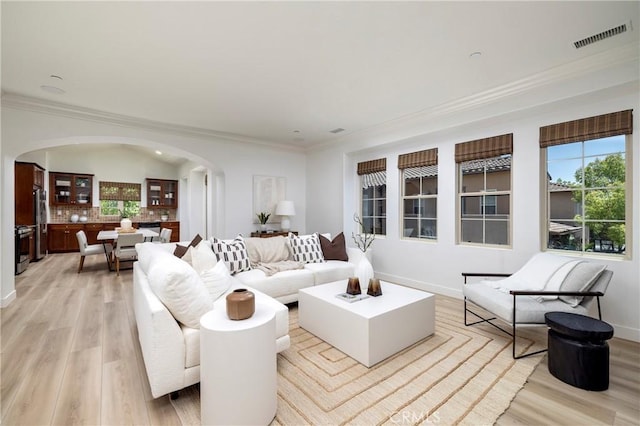 74 Townsend, Irvine, CA 92620 - living area featuring arched walkways, light wood-style floors, and ornamental molding