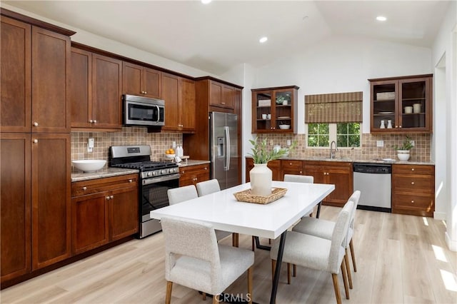 74 Townsend, Irvine, CA 92620 - kitchen featuring stainless steel appliances, light wood-style floors, glass insert cabinets, vaulted ceiling, and recessed lighting