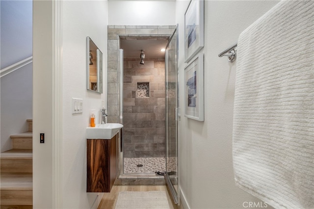 74 Townsend, Irvine, CA 92620 - bathroom featuring a shower stall, vanity, and wood finished floors