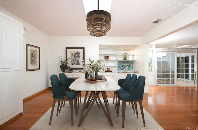 3621 Vista Campana S Unit 11, Oceanside, CA 92057 - dining area with light wood finished floors and a chandelier