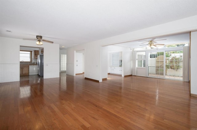 3621 Vista Campana S Unit 11, Oceanside, CA 92057 - unfurnished living room with a ceiling fan, wood finished floors, and plenty of natural light