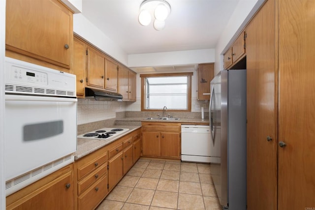 3621 Vista Campana S Unit 11, Oceanside, CA 92057 - kitchen featuring white appliances, under cabinet range hood, decorative backsplash, light countertops, and light tile patterned flooring