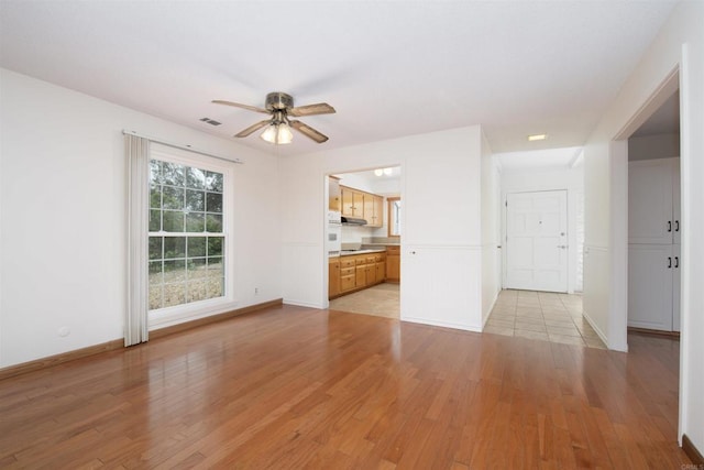 3621 Vista Campana S Unit 11, Oceanside, CA 92057 - unfurnished living room with light wood-type flooring and ceiling fan