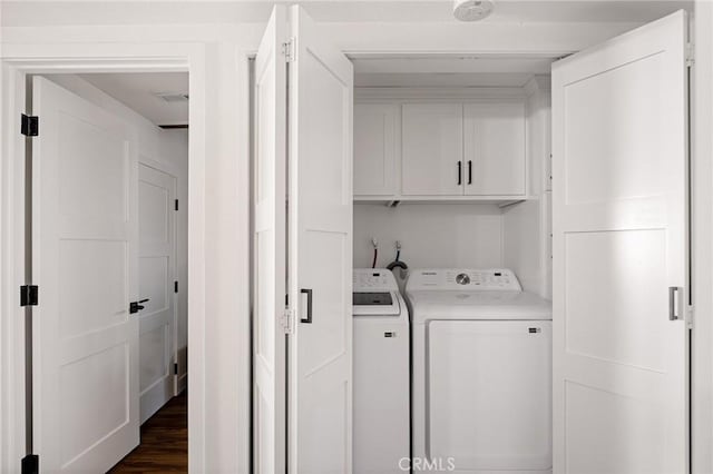 345 Maple Dr, Lake Arrowhead, CA 92352 - washroom with separate washer and dryer, cabinet space, and dark wood-type flooring