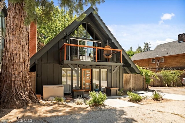 345 Maple Dr, Lake Arrowhead, CA 92352 - rear view of property featuring board and batten siding, a balcony, and a chimney