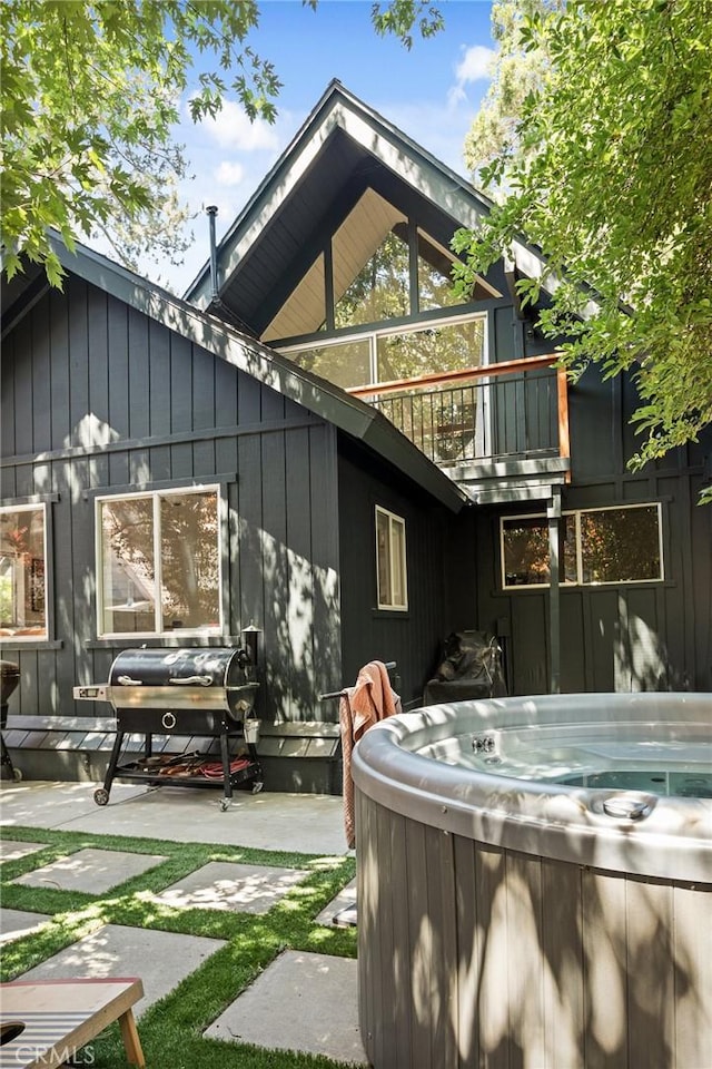 345 Maple Dr, Lake Arrowhead, CA 92352 - rear view of house with a hot tub, a patio area, and a balcony