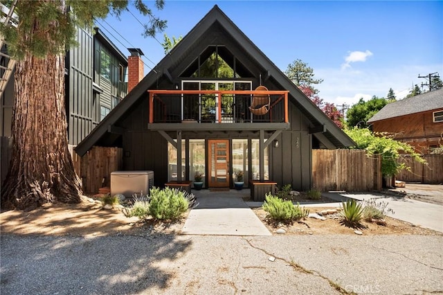 345 Maple Dr, Lake Arrowhead, CA 92352 - rear view of property with a chimney, board and batten siding, and a balcony