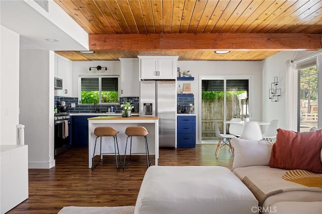 345 Maple Dr, Lake Arrowhead, CA 92352 - living room with healthy amount of natural light, dark wood-style floors, and a wood ceiling with exposed beams