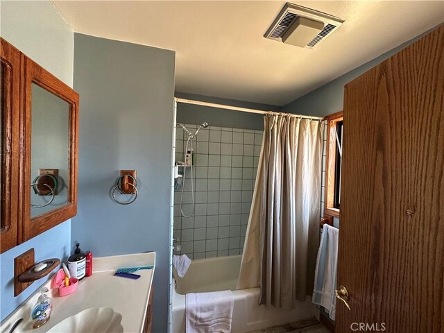 18211 Hercules St, Hesperia, CA 92345 - bathroom with vanity and shower / tub combo with curtain