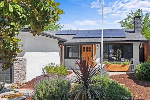 4913 Sparrow Hawk Ln, Paso Robles, CA 93446 - view of front of house featuring a chimney, stucco siding, solar panels, and a shingled roof
