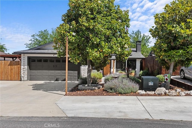 4913 Sparrow Hawk Ln, Paso Robles, CA 93446 - obstructed view of property featuring driveway, a garage, a chimney, and stone siding