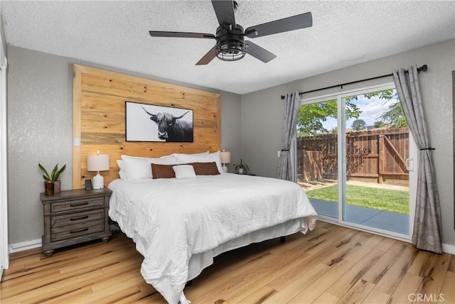 4913 Sparrow Hawk Ln, Paso Robles, CA 93446 - bedroom with access to outside, a textured ceiling, light wood-style flooring, a textured wall, and a ceiling fan