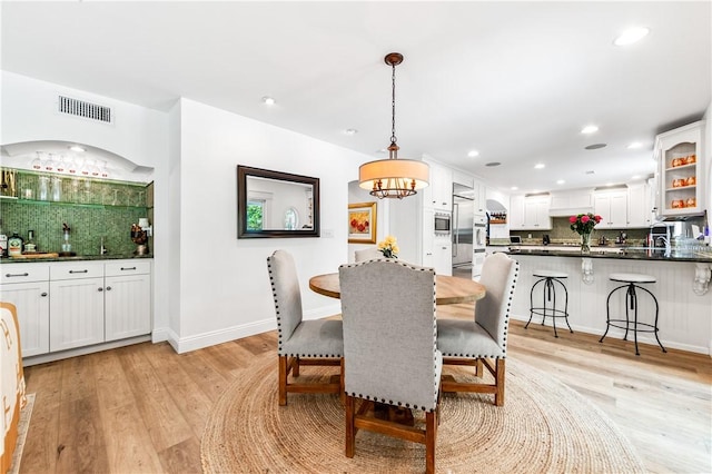 2726 Cardinal Dr, Costa Mesa, CA 92626 - dining space with light wood-type flooring, recessed lighting, bar, and a chandelier
