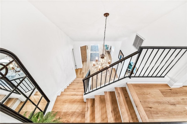 2726 Cardinal Dr, Costa Mesa, CA 92626 - staircase with a chandelier and wood finished floors
