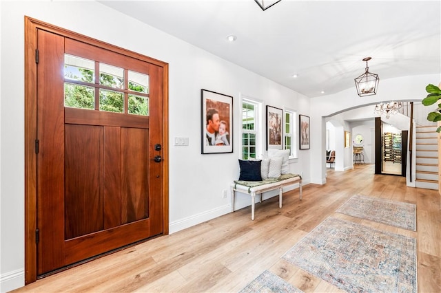 2726 Cardinal Dr, Costa Mesa, CA 92626 - foyer with arched walkways, light wood-type flooring, stairway, recessed lighting, and a chandelier