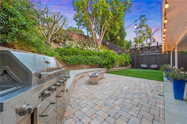 2726 Cardinal Dr, Costa Mesa, CA 92626 - patio terrace at dusk with a patio, a fenced backyard, and area for grilling