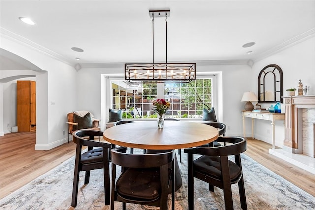 2726 Cardinal Dr, Costa Mesa, CA 92626 - dining room featuring light wood-type flooring, ornamental molding, a chandelier, arched walkways, and recessed lighting