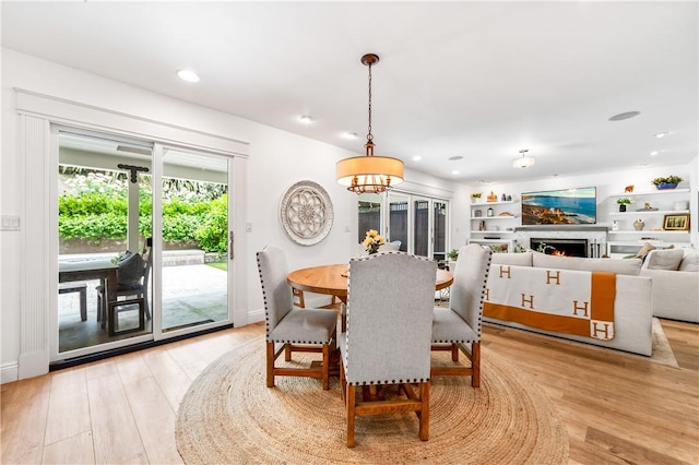 2726 Cardinal Dr, Costa Mesa, CA 92626 - dining room with light wood-type flooring, a chandelier, a lit fireplace, and recessed lighting