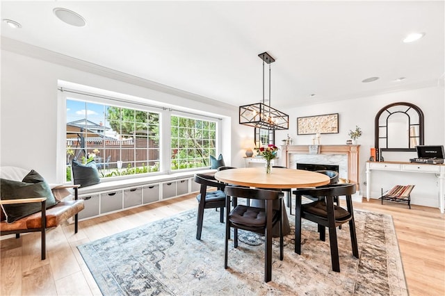 2726 Cardinal Dr, Costa Mesa, CA 92626 - dining area with a high end fireplace, light wood-style floors, crown molding, and recessed lighting