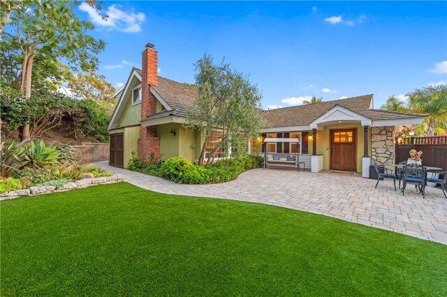2726 Cardinal Dr, Costa Mesa, CA 92626 - rear view of house featuring a chimney, a patio area, stucco siding, and stone siding