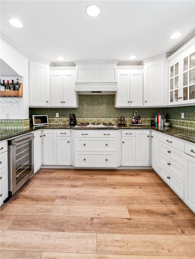 2726 Cardinal Dr, Costa Mesa, CA 92626 - kitchen with wine cooler, white gas cooktop, custom range hood, dark countertops, and recessed lighting