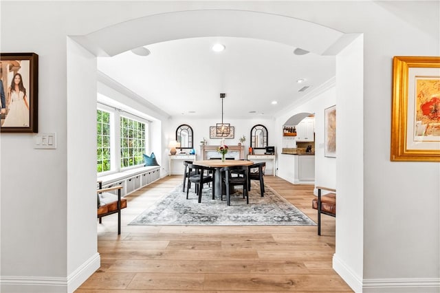 2726 Cardinal Dr, Costa Mesa, CA 92626 - dining room with arched walkways, ornamental molding, light wood-style flooring, and recessed lighting