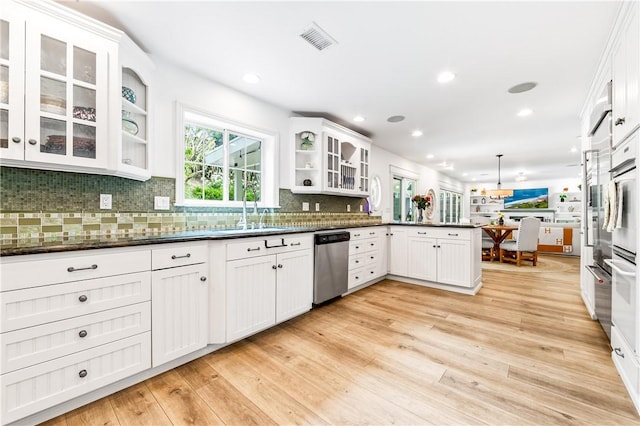 2726 Cardinal Dr, Costa Mesa, CA 92626 - kitchen with dishwasher, a peninsula, white cabinetry, tasteful backsplash, and light wood-type flooring