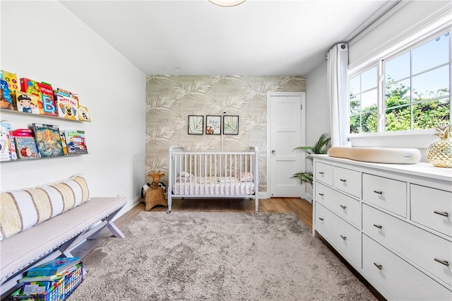 2726 Cardinal Dr, Costa Mesa, CA 92626 - bedroom with wallpapered walls, light wood finished floors, and an accent wall